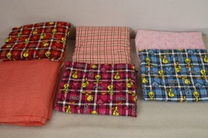 lot 446 image: Bulk Sewing Quilting Backing FLANNEL Fabric Plaid Tweety Bird Etc
