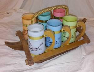 lot 338 image: Vintage Siesta Ware Tiki Mugs with Wood Outrigger Canoe Carrier.