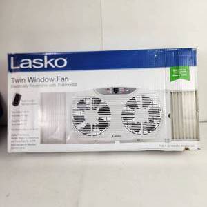 lot 55 image: Lasko Twin Window Fan Electronically Reversible With Thermostat Multi Function Remote Control Expander Panels Damaged Box