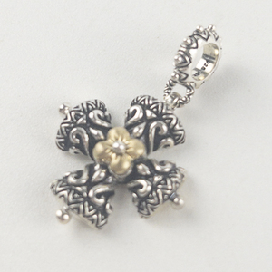 lot 51 image: Barbara Bixby sterling and 18K yellow gold cross charm. Estimated Replacement value $150