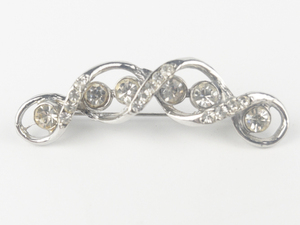 lot 193 image: Rhinestone Twist Silver Tone Base Metal Brooch .