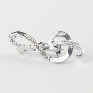 lot 196 image: Music Treble Clef Silver Tone Base Metal Brooch .