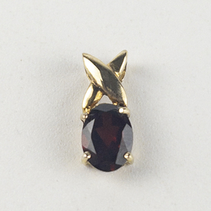 lot 244 image: Oval Brilliant Cut Garnet gold tone base metal pendant (no chain).