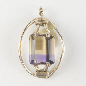 lot 252 image: New Old Stock Handcrafted wrapped emerald cut Ametrine gold filled wire pendant (no chain), set with ametrine. Replacement value $140