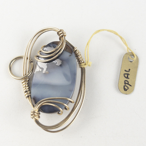 lot 251 image: New Old Stock Handcrafted wrapped opal gold filled wire pendant (no chain), set with opal. Replacement value $125