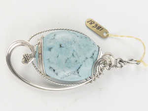 lot 257 image: New Old Stock Handcrafted large wrapped oval turquoise stainless steel wire pendant (no chain), set with turquoise. Replacement value $115