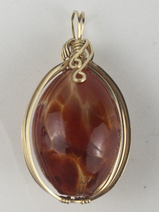 lot 260 image: New Old Stock Handcrafted large wrapped red orange blown glass gold filled wire pendant (no chain). Replacement value $85