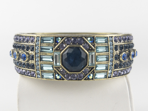 lot 263 image: Heidi Daus Purple & Blue Crystal Lavish Layers Gold Tone Base Metal Hinged Bangle.