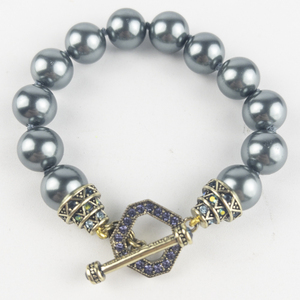 lot 265 image: Heidi Daus Blue Simulated Pearl With Blue & Purple Crystal Gold Tone Base Metal Bracelet.