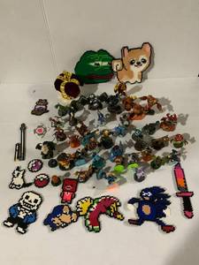 lot 107 image: Gaming Collection Featuring Skylanders Figures and Unique Pixel Art Pieces