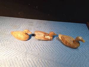 lot 63 image: 1 Duck carved from cedar fence post and 2 ducks made out of corn husks