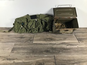 lot 286 image: Ammo Can with Brass and Some Type of Military Ammo Pack
