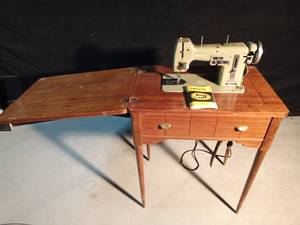 lot 190 image: Vintage Necchi sewing machine in cabinet with manual