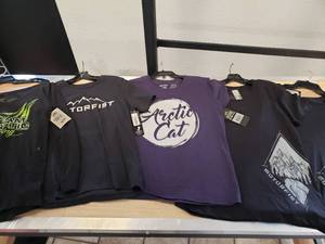 lot 242 image: 5 Womens Large t-shirts - 1 purple the rest are black - some Artic Cat and some Motorfist