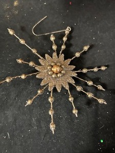 box of bronze colored Metal Snowflake Ornaments