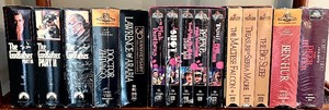 lot 125 image: Vintage Collection of Famous VHS Movies with Wood Stand