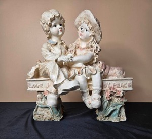 lot 55 image: Vintage Porcelain Figurine of Children Sitting on a Bench - Love and Joy Peace