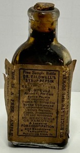 lot 309 image: Antique 1920s Dr. W. B. Caldwells Syrup Pepsin Monticello, ILL. Free Sample Bottle With Paper label Drug Store Decor