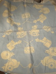 lot 345 image: Vintage 60s Satin Edges Flannel BABY BLANKET Depicting Toys Blue  Yellow