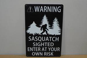 lot 99 image: Novelty Metal Sign -Warning Sasquatch