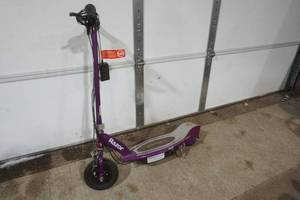 lot 379 image: Purple Razor scooter and electric charging cord