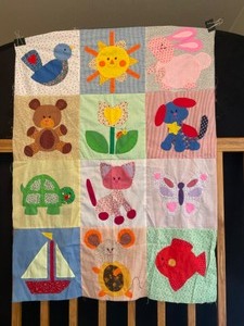lot 14 image: Vintage Twelve-Block Baby Crib Quilt Boat, Butterfly & Bright-Eyes Bundled In One Adorable Hand-Stitched Quilt Ready for Your Finishing Touch