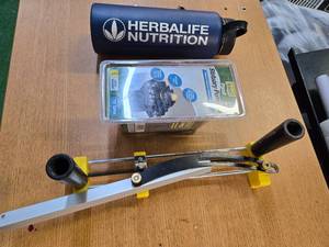 lot 45 image: Lot of 3 Items  Statuary Pump75 Herbalife Nutrition Metal Can and a hand Tool