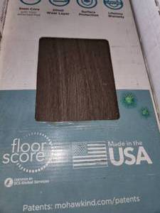 lot 69 image: 4 boxes pergo dark chocolate walnut vinyl flooring