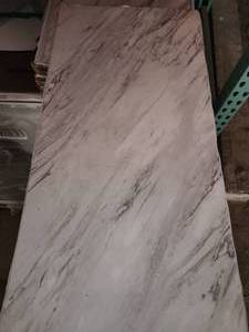 lot 73 image: 155 boxes carrara marble 12x24 peel and stick Vinyl tile