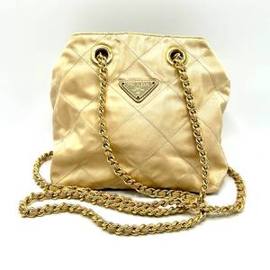 lot 14A image: Prada Quilted Satin Bucket Bag in Gold with Chain Strap $1,200 Used Retail