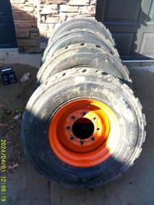 lot 7 image: Set of 4, 12-16.5 Bobcat Tires and Wheels