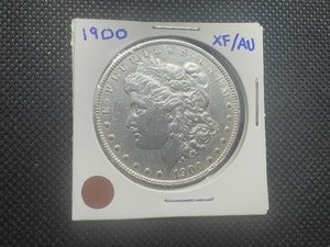 1900 Morgan Dollar, Very Minor Marks in Fields and on Cheek, Minor Ding on Rim, Closer to AU Condition