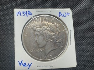 1934D Key Date Peace Dollar, Very Minor Marks in Fields and on Cheek, Minor Ding on Rim, Uniform Toning, AU