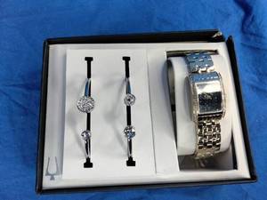lot 218 image: Bulova Womens Caravelle by Bulova Gold Tone Square Watch with Black Sparkle Face and Bangle Bracelet Set