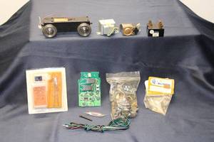 lot 114 image: Mixed Lot of Model Train Components Including Motor, Circuit Boards, and Accessories
