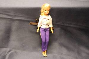 lot 133 image: Vintage Blonde Doll with Braided Hair and Patterned Outfit
