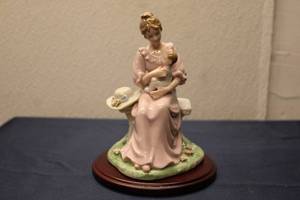 lot 151 image: Vintage Porcelain Figurine of a Mother Holding Child with Floral Base