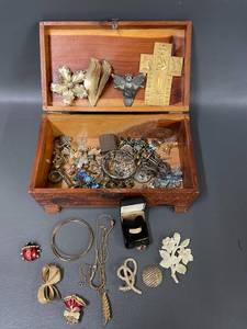 lot 178 image: Vintage Jewelry Collection with Ornate Pins, Religious Icons in Carved Wooden Box