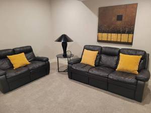 lot 51 image: Dual Reclining Faux Leather Sofa in Black.