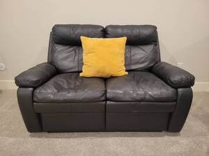 lot 52 image: Dual Reclining Faux Leather Loveseat in Black.
