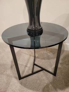 lot 55 image: Contemporary Side Table. Removeable tinted glass on top of intersecting angles. Black metal base.