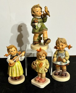 lot 96 image: Four Vintage Hummel Figurines including Hummel Figurine Brought You a Gift, Hummel Figurine Floor Girl and More