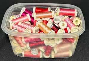 lot 151 image: Bin of Assorted Red and Pink Thread Spools