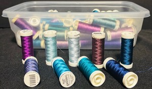 lot 153 image: Bin of Assorted Blue and Purple Thread Spools
