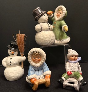 lot 341 image: Goebel Figurine Child Sledding, Goebel Winter Wonderland Girl Applying Carrot Nose on Snowman and More