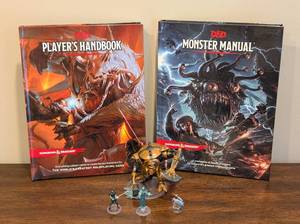 lot 115 image: Dungeons and Dragons Manual, Handbook and Three Figurines