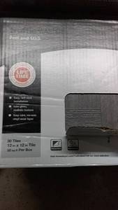 lot 147 image: Lot of 8 Boxes of TrafficMASTER Grey Wood Parquet Peel and Stick Tiles - 12 x 12 Tiles