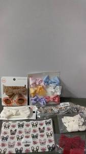lot 185 image: Collection of Hair Accessories Including Bows, Headbands, and Sunglasses