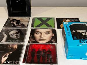 lot 230 image: Music CD Collection  JLab Headphones