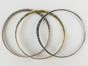 RLM Studio (Robert Lee Morris) Set Of Three Tapered Brass, Sterling Silver & Copper Bangles.